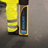 image of a man holding a ezicat i550xf cable locator