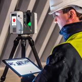 image of a leica rtc360 laser scanner being used by a person inside of a warehouse or construction site
