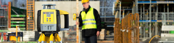 Image of a Geomax Zone20H Rotating Laser being used by a worker on a frames construction site, the rotating laser is giving out the datum to the worker that is holding the ZRD105 digital receiver which is capable of display MM accurate readings. Show more